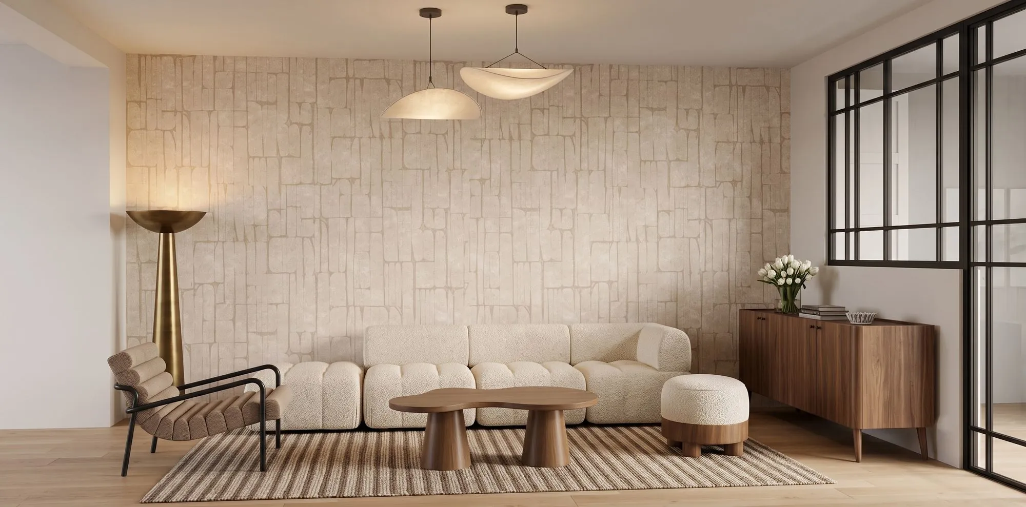 Semard — salon avec banquette beige et table basse ronde face au mur en pierre, Atelier Nola